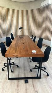 a conference room with a wooden table and chairs at Designer Cave Condo with Beach Club included - Hotel Zone Tulum in Tulum +108 photos