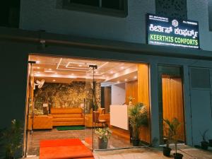 an entrance to akerskus contracts office with orange furniture at Keerthis Comforts Bengaluru Airport Hotel in Bengaluru