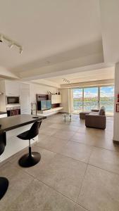 a large living room with a table and a couch at Sliema Seaview Apartment- Valletta Views - APT 8, 49 Tigne Point Mansions in Sliema