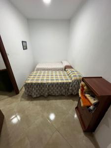 a small bedroom with a bed and a table at Casa en la Huertecilla in Lora del Río