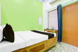 a bedroom with a large bed and a window at Hotel O yuv in Patna