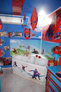 a bathroom with a superhero themed room with a tub at Catania SpidermanHouse I in CTA