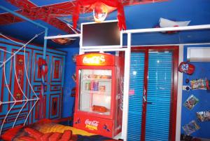 a room with a red refrigerator with a tv on it at Catania SpidermanHouse I in CTA