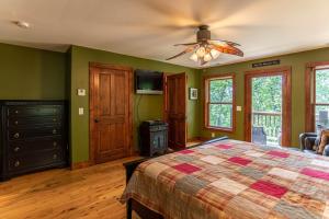 a bedroom with a bed and a ceiling fan at A Peak of Heaven in Boone