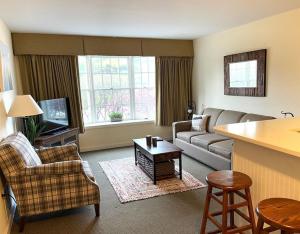 a living room with a couch and a table at Ski On Off 1BR Suite 1st Flr Sleeps 4 Jiminy Peak in Hancock