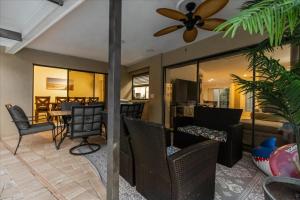 a living room with a ceiling fan and a dining room at Dream Home Family Retreat 4BR Near the Gulf in Palm Harbor