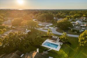 an aerial view of a house with a swimming pool at Dream Home Family Retreat 4BR Near the Gulf in Palm Harbor