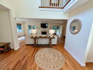 a living room with a table and a couch at Haven on Glynn by Rove Travel - Coastal Luxury in Shelter Island Heights