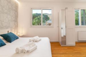 a bedroom with two beds with towels on them at Luxury apartment Villa Vera Mondello beach with pool in Palermo +51 photos