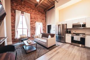 a living room with a couch and a kitchen at Three Trails Downtown Elkin in Elkin