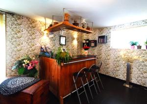a bar in a room with floral wallpaper at La Grange de David gîte de standing 5 ch 5 sdb - Access-i in Hamoir