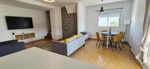 a living room with a couch and a table at Apartamento LaPlaza Villamartin in Los Dolses
