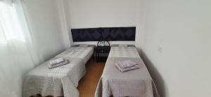 two beds in a room with towels on them at Apartamento LaPlaza Villamartin in Los Dolses +10 photos