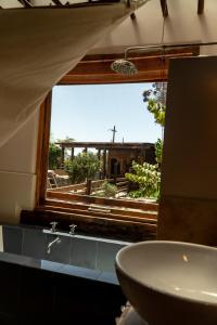a bathroom with a sink and a window with a view at Cabaña de lujo en La Serena in La Serena