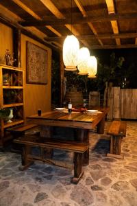 a dining room with a wooden table and chandeliers at Cabaña de lujo en La Serena in La Serena