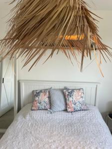 a bedroom with a bed with two pillows at Entire Apartment in Pretty Coastal Village in Cubert