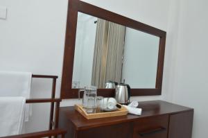 a mirror on a table in a bedroom at BeeYu River Lodge Weligama in Weligama