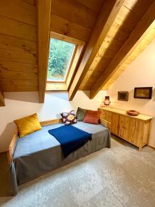 ベドジホフにあるapartmány V Leseのベッドルーム1室(屋根裏部屋に大型ベッド1台付)
