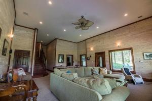 a living room with a couch and a ceiling fan at Stoneledge Manor in Banner Elk +45 photos