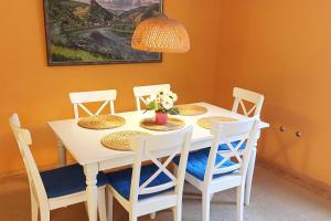 a white table with chairs and a vase of flowers on it at 2 Bed Apt Sleeps 5 - Rooftop Terrace Wifi in Cochem