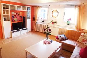 a living room with a couch and a table at 2 Bed Apt Sleeps 5 - Rooftop Terrace Wifi in Cochem