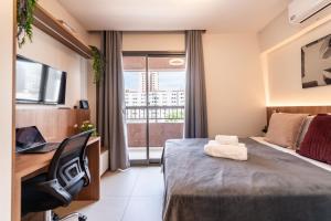 a hotel room with a bed and a desk and a window at Edificio Le Petit - Próx Metrô Vila Mariana in Sao Paulo +56 photos