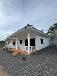 a small white house with a lot of windows at Grandma Samui Garden in Ban Tai