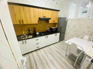 a small kitchen with a sink and a stove at Mellinium apartment in old city in Bukhara