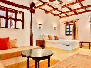 a living room with two beds and a table at La Bergerie Ouirgane - Serenity Lodge in Asni