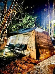 a tent sitting on the side of a street at Rahsia Riverside Orchard Campsite at Janda Baik , Pahang in Bentong