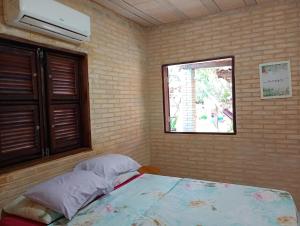 a bedroom with a bed and a window at Casa das Gaúchas in Canoa Quebrada +36 photos