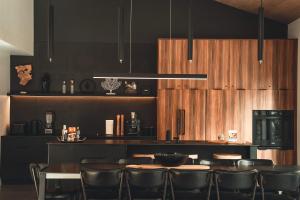 a restaurant with a bar with tables and chairs at Two Zen Houses - Villas and Spas in Morin Heights +16 photos