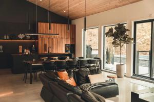 a living room with a couch and a table at Two Zen Houses - Villas and Spas in Morin Heights