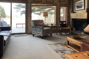 a living room with a chair and a fireplace at Glacier B in Jackson