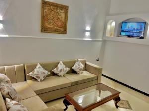 a living room with a couch and a coffee table at Villa Sunrise in Luxor