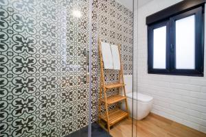 a bathroom with a toilet and a glass shower at Villa May en Riegu Vidiago Llanes in Vidiago +57 photos