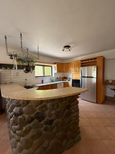 a kitchen with a stone counter top in a room at Country house in Golan in Kidmat Tsvi