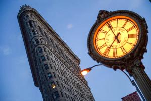 a large clock in front of a tall building at Holiday Inn Express NYC Chelsea - NoMad Area by IHG in New York