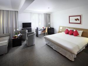 a hotel room with a large bed and a desk at Novotel Praha Wenceslas Square in Prague +151 photos