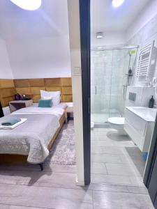 a bedroom with a bed and a bathroom with a shower at Apartamenty Pokoje Willa Bielany in Warsaw +42 photos