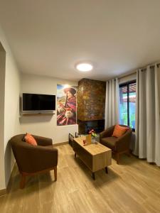 a living room with two couches and a tv at Oro Andino Lodge in Caraz