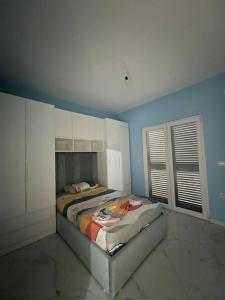 a bedroom with a bed in a blue room at Poppe Home in Domje +4 photos