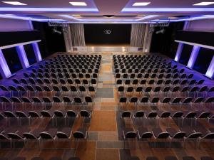 an empty auditorium with chairs and a stage at Sofitel Warsaw Victoria in Warsaw