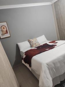 Ένα ή περισσότερα κρεβάτια σε δωμάτιο στο Ekukhanyeni Guest house