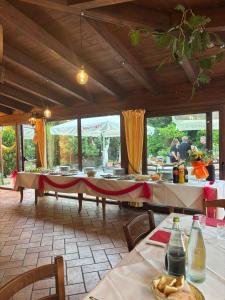 a dining room with tables and people in the background at Agriturismo i Due Mori in Treia