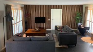 a living room with two couches and a coffee table at Onder het dak van Brabant in Mierlo