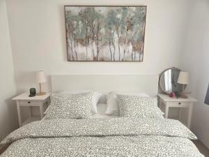 a bedroom with a bed with two nightstands and a painting at Kuća za odmor Brlog in Otočac +32 photos