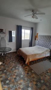 a bedroom with a bed and a table in it at Casa Bella Vizcaína in Mineral de Pozos