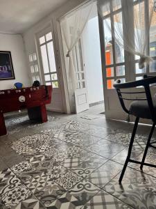a living room with a table and a rug on the floor at Casa Bella Vizcaína in Mineral de Pozos