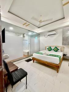 a bedroom with a bed and a chair at Hotel Aaditya Inn in Hinjewadi